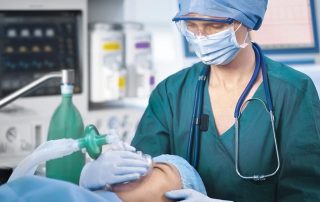 Nurse using anesthesia machine