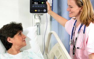 doctor reading vital signs monitor